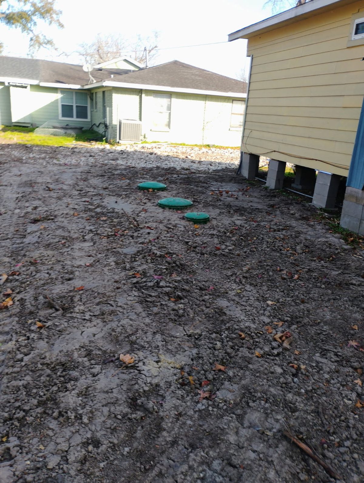 Hydro Action aerobic system green access lids near residential property